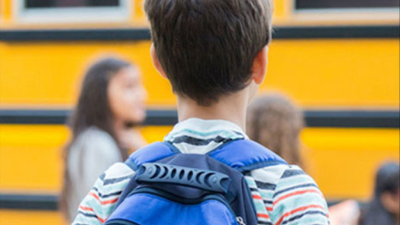 Rear view of a child with a backpack